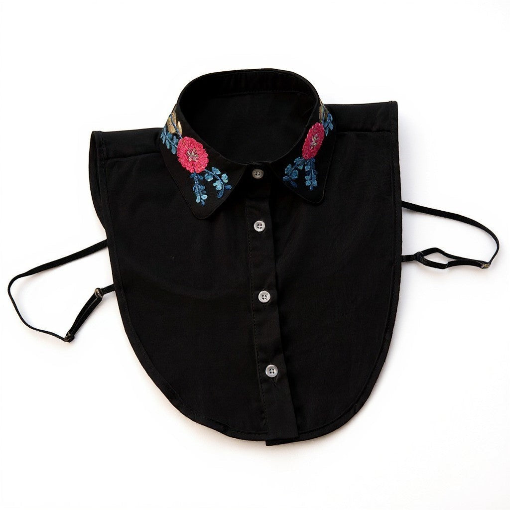 Simply Collars black detachable collar with floral embroidery in pink and blue. Features button front and adjustable straps.