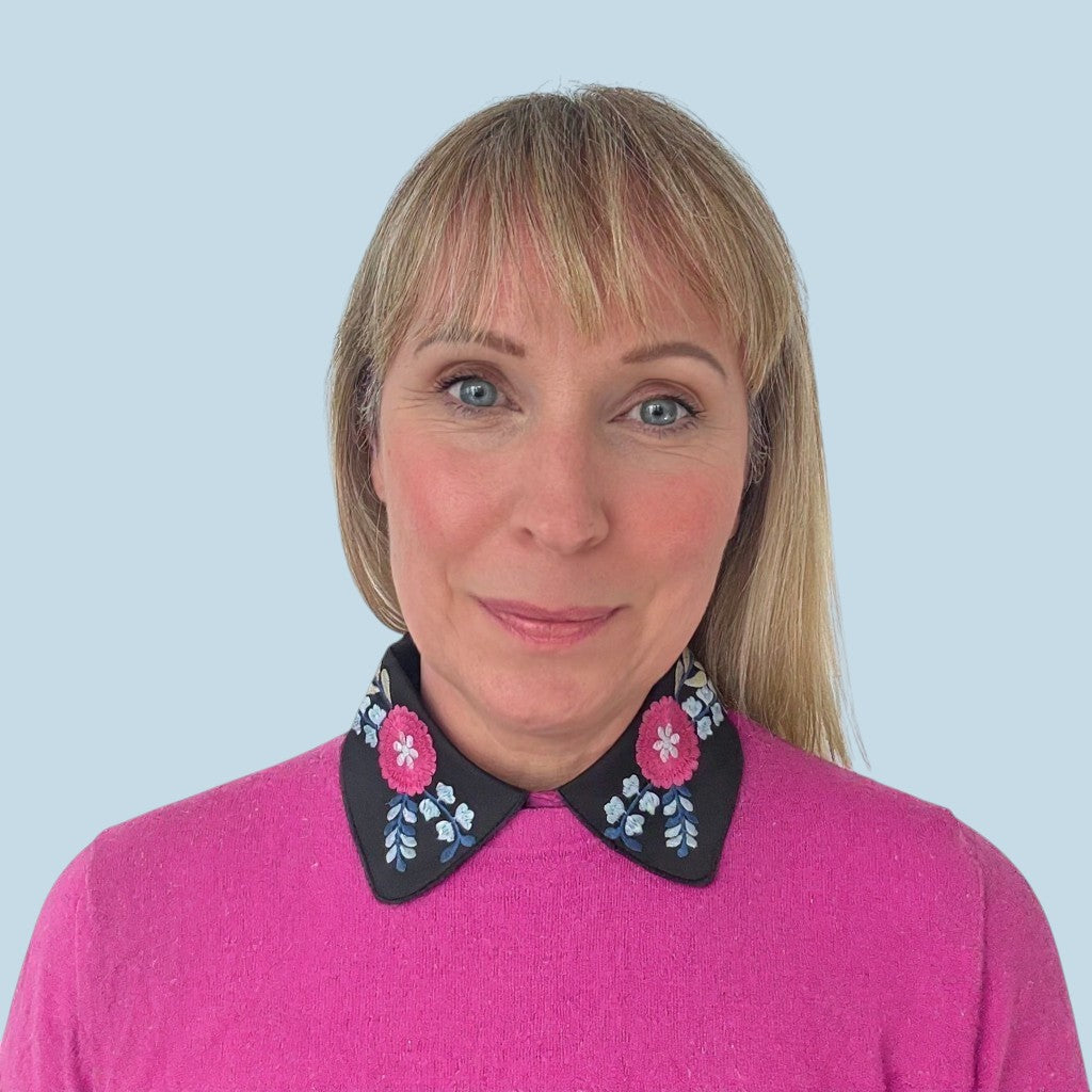 Simply Collars black detachable collar with vibrant pink and blue floral embroidery. Adds a pop of color to outfits.