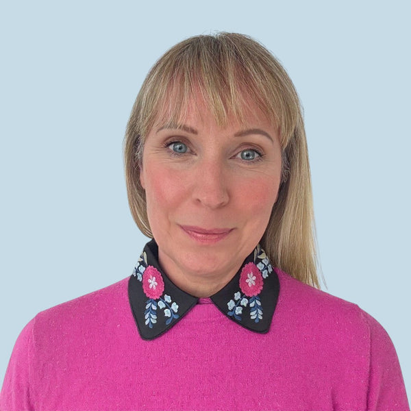 Simply Collars black detachable collar with vibrant pink and blue floral embroidery. Adds a pop of color to outfits.