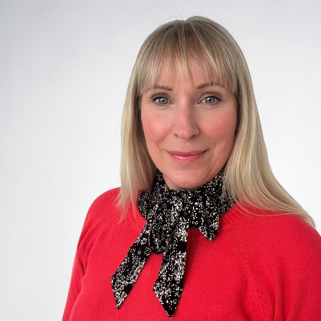 Simply Collars black and white ditsy print collar with a bow tie detail, worn under a red sweater.