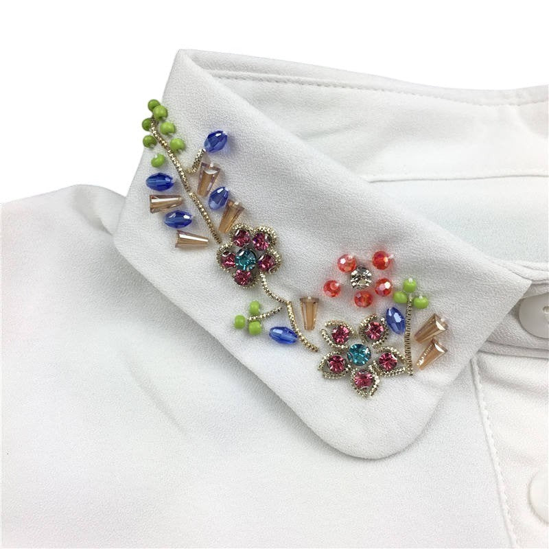 Simply Collars white detachable collar with vibrant floral beadwork and blue, pink, and green embellishments.